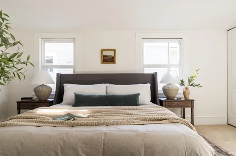 a bedroom with a bed and window