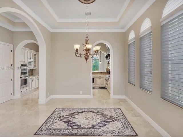 a kitchen with a stove a sink and a window