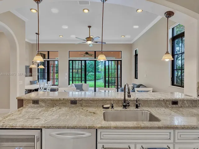 a kitchen with a table chairs and white cabinets