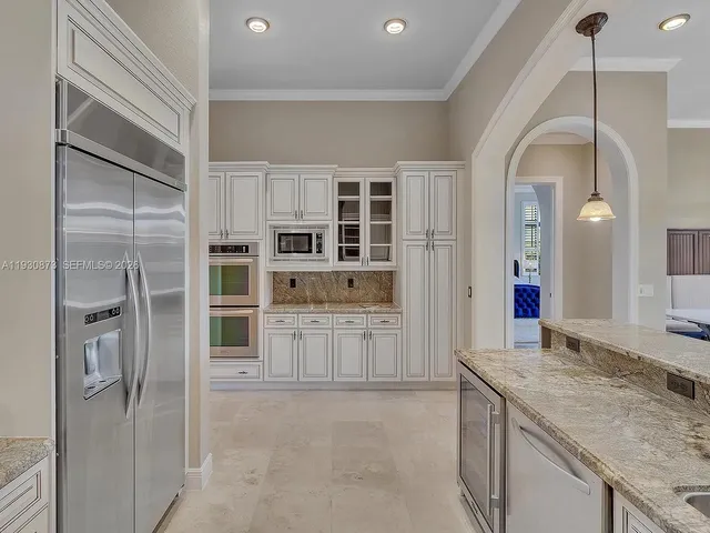 a spacious bedroom with a large bed and a large window