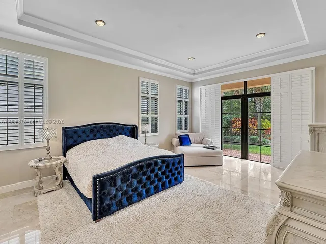 a bathroom with a granite countertop sink a mirror and a bathtub