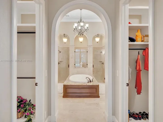a bathroom with a granite countertop sink tub shower and a mirror