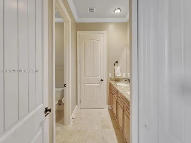 a view of a room with wooden floor and a ceiling fan