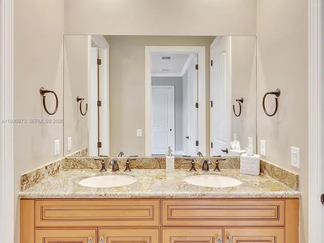 a living room with granite countertop furniture and a flat screen tv