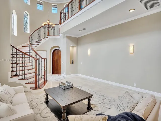 a living room with furniture and a floor to ceiling window