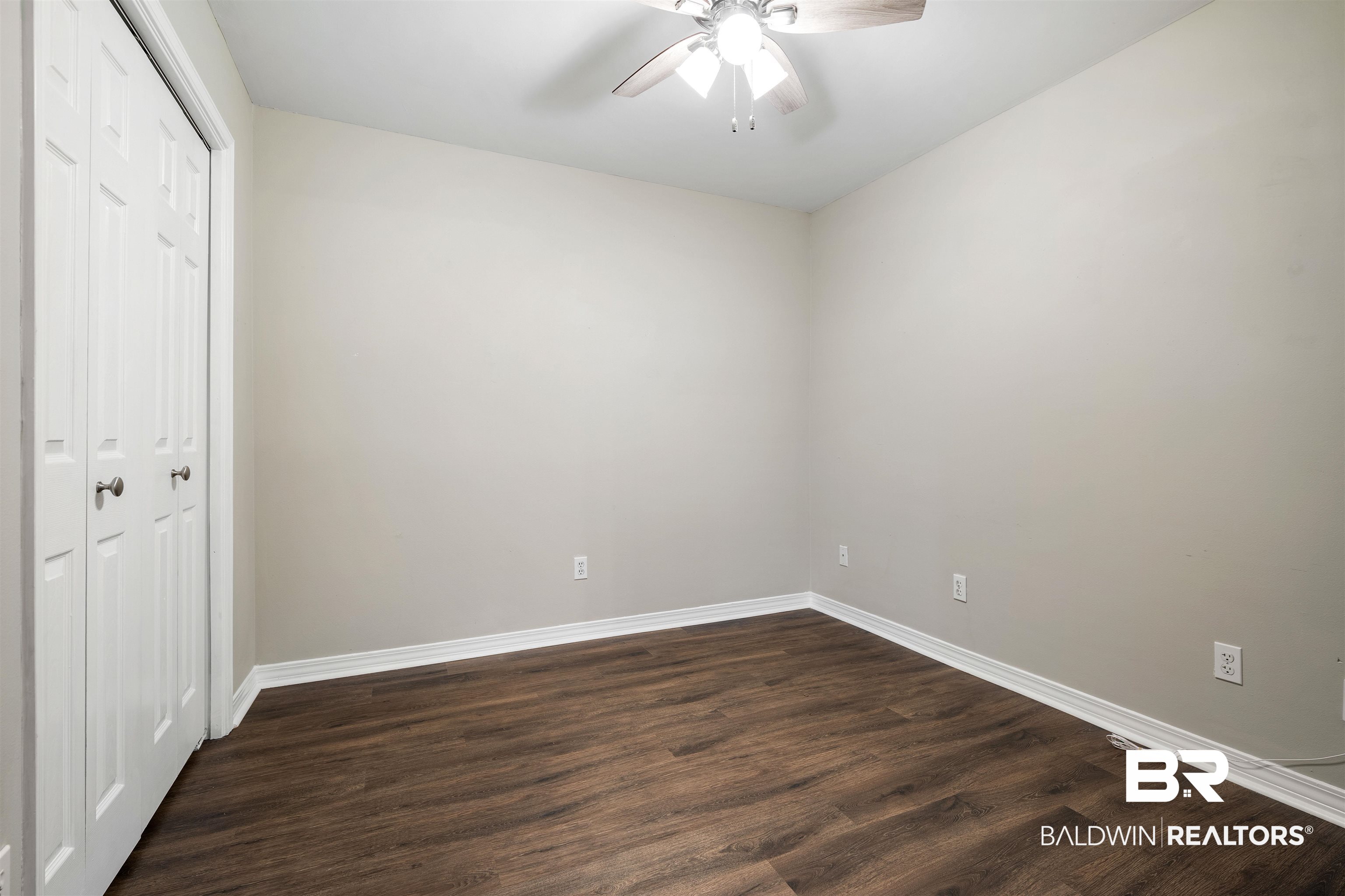628 Spring Lake Court Mobile, AL 36695 - Photo 14 of 25 Unfurnished bedroom featuring dark hardwood / wood-style floors, ceiling fan, and a closet