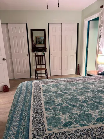 a bedroom with a bed and a painting on the wall