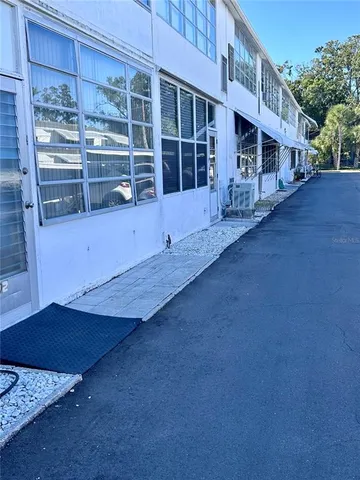 a front view of a house with a yard glass top table and chairs