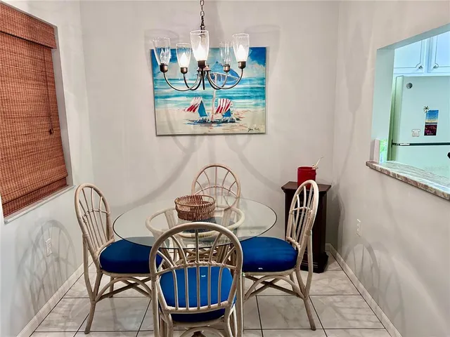 a view of a dining room with furniture a rug and wooden floor