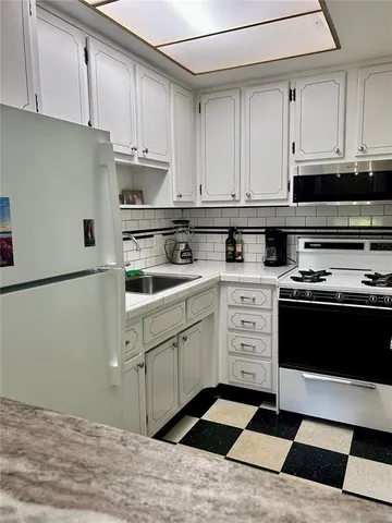 a kitchen with appliances cabinets and a sink