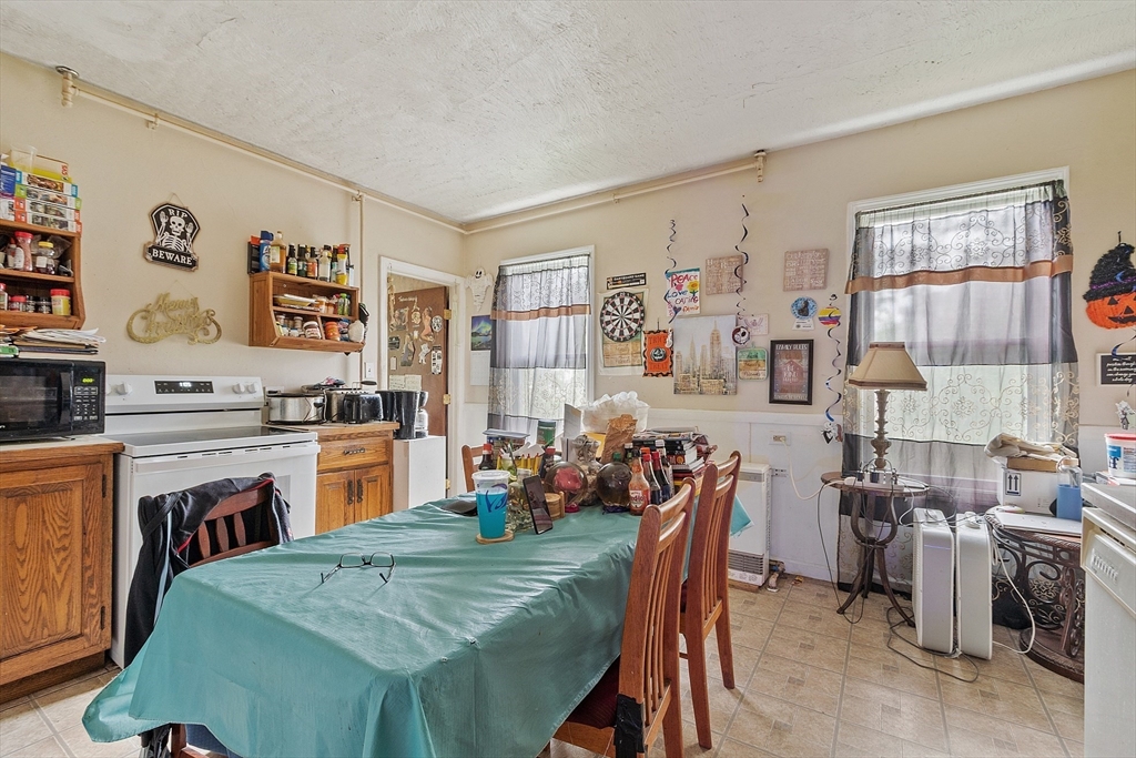 132 Hazel Street Fitchburg, MA 01420 - Photo 11 of 26 a open dining room with stainless steel appliances furniture a window and a kitchen view