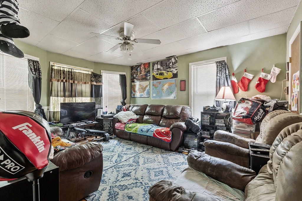 132 Hazel Street Fitchburg, MA 01420 - Photo 13 of 26 a living room with furniture and a flat screen tv
