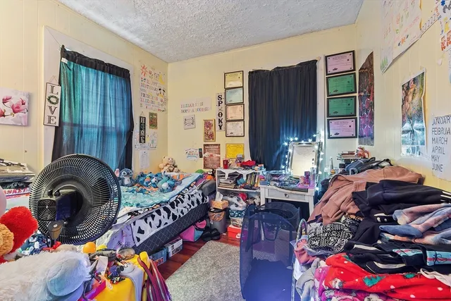 a bedroom with furniture and a large window