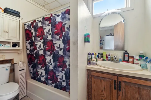 a bathroom with a sink vanity mirror and toilet