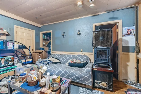 a bedroom with furniture and a wooden floor