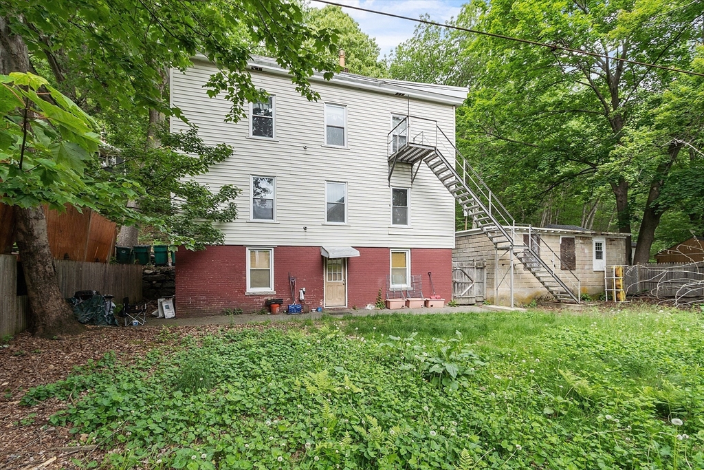 132 Hazel Street Fitchburg, MA 01420 - Photo 21 of 26 a view of a house with a yard and sitting area