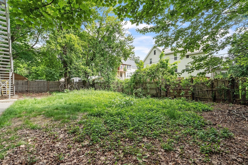 132 Hazel Street Fitchburg, MA 01420 - Photo 22 of 26 a view of a garden with a tree