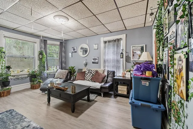 a living room with furniture and wooden floor