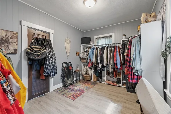 a view of walk in closet with clothes