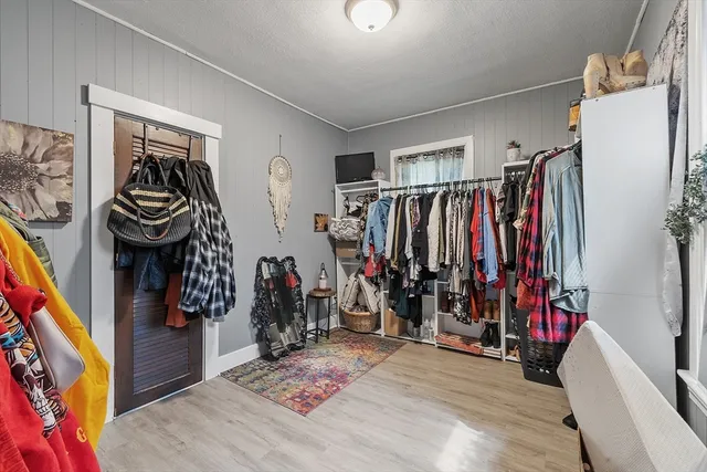 a view of walk in closet with clothes