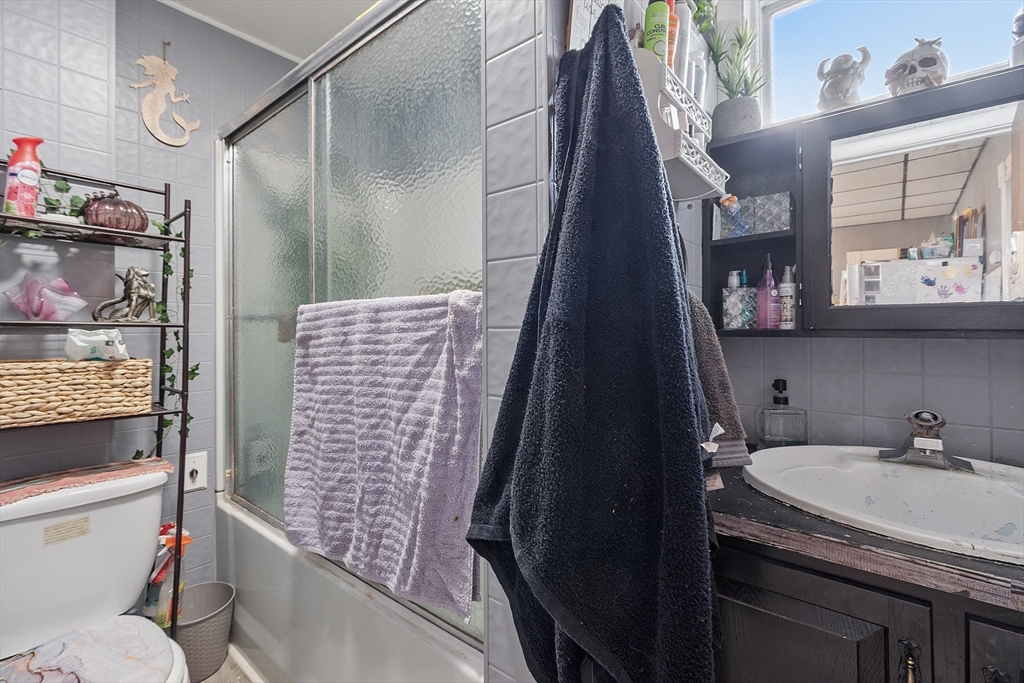 132 Hazel Street Fitchburg, MA 01420 - Photo 9 of 26 a bathroom with a granite countertop sink a toilet and shower