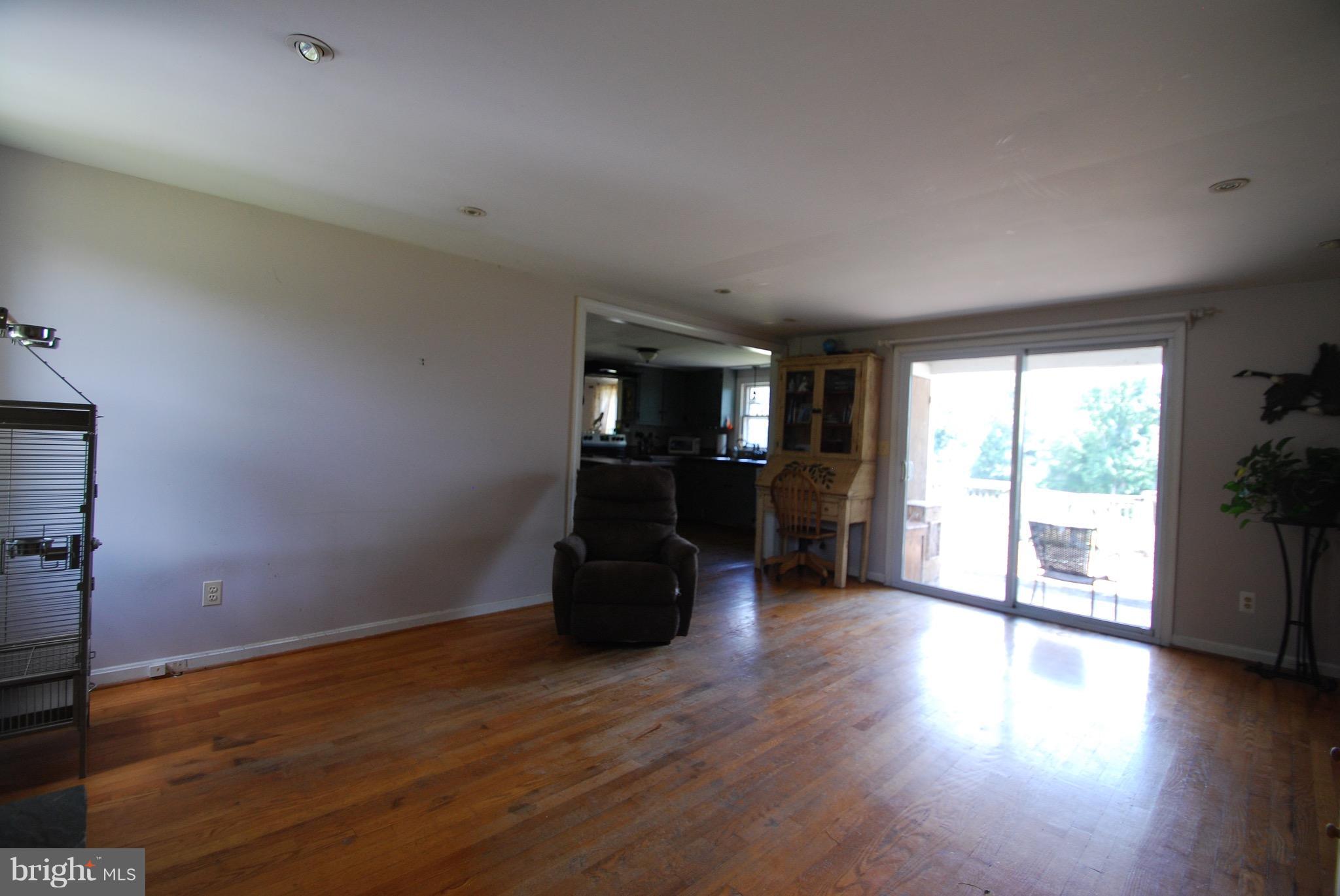 10775 Cliff Mills Road Marshall, VA 20115 - Photo 2 of 17 an empty room with wooden floor and windows