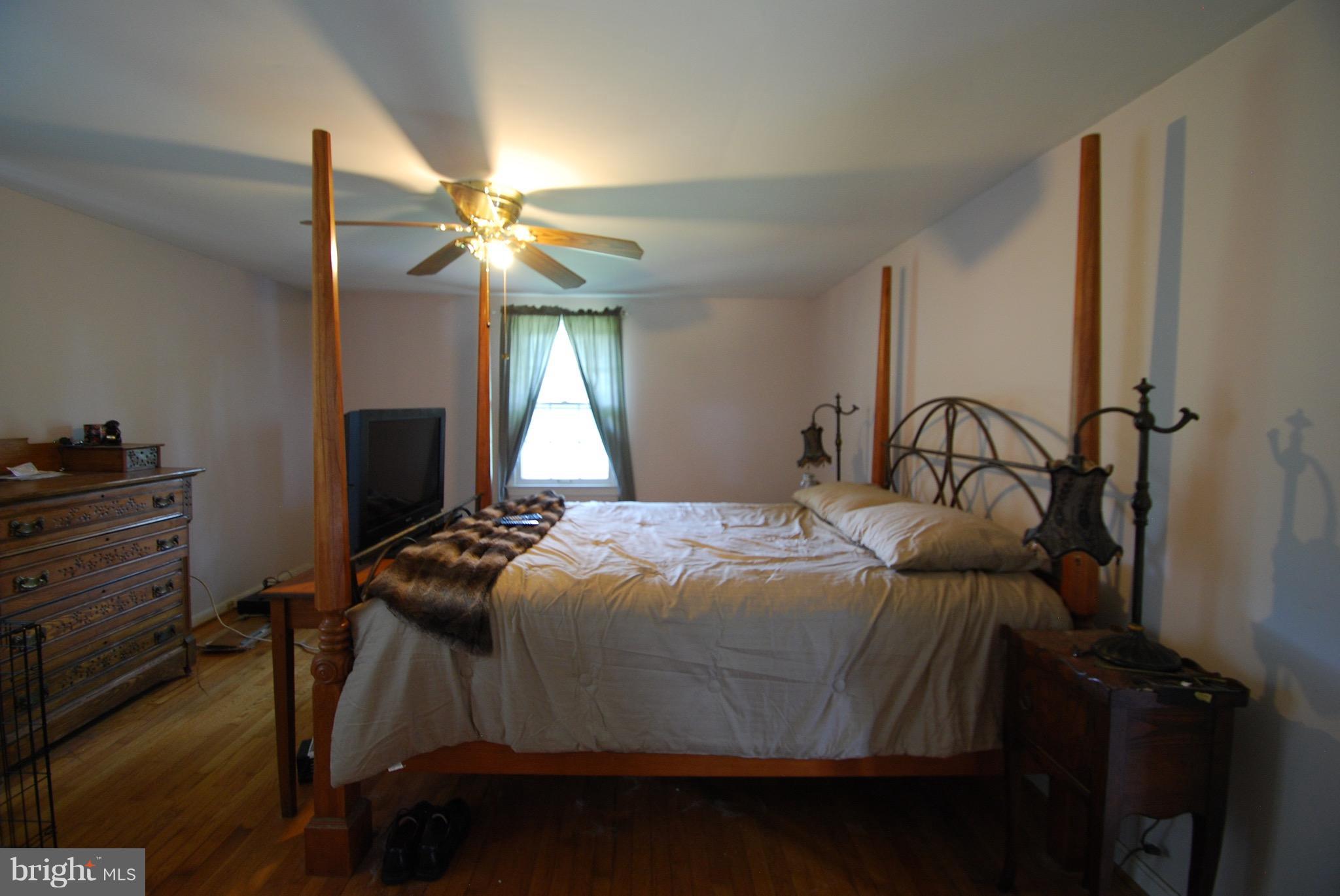 10775 Cliff Mills Road Marshall, VA 20115 - Photo 11 of 17 a bedroom with a bed and a chandelier