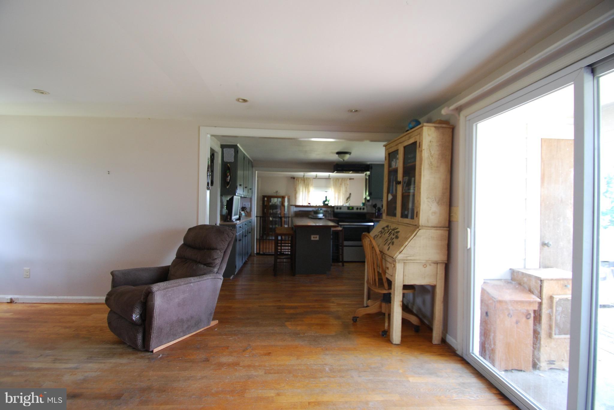 10775 Cliff Mills Road Marshall, VA 20115 - Photo 3 of 17 a living room with furniture and a flat screen tv