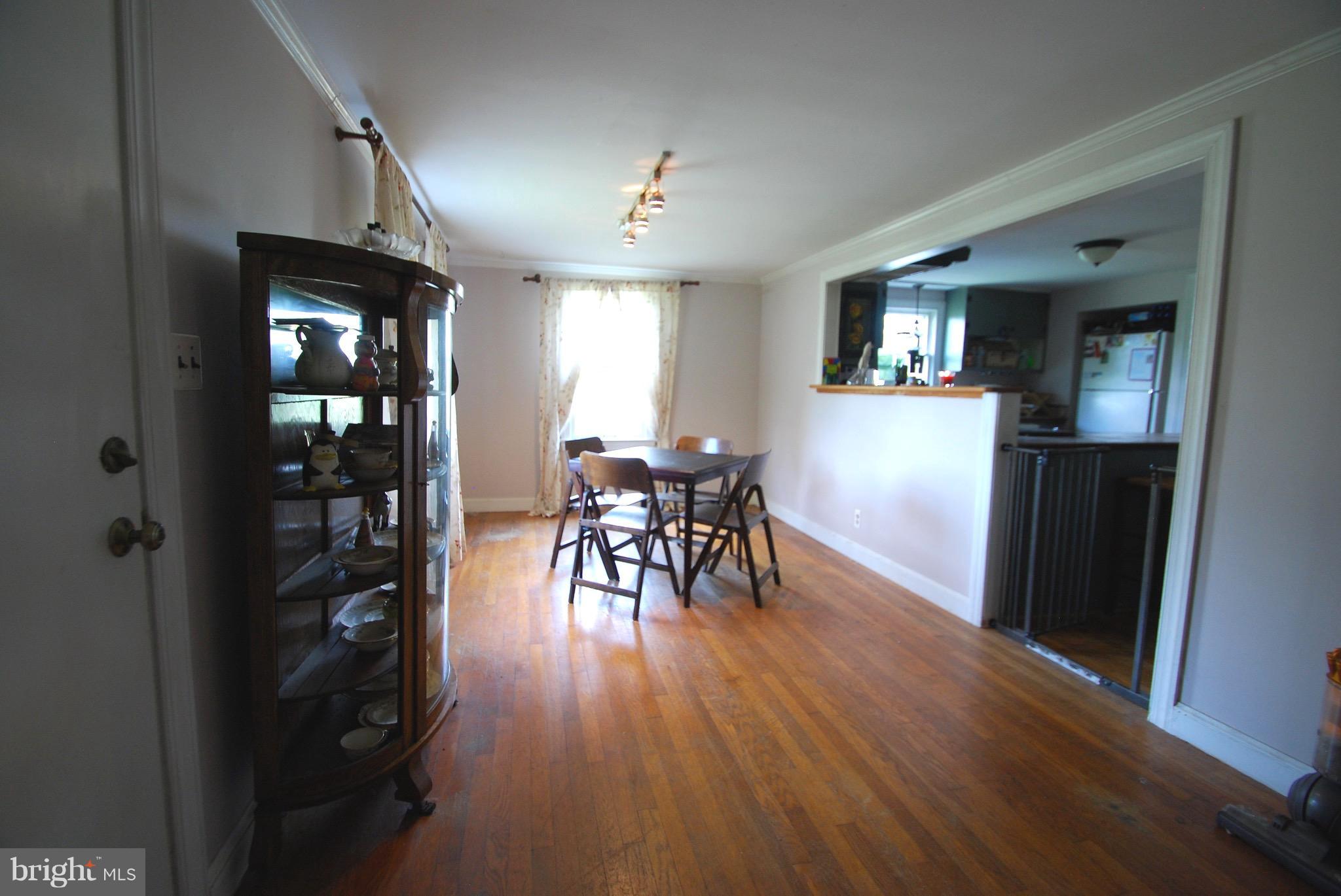 10775 Cliff Mills Road Marshall, VA 20115 - Photo 5 of 17 a view of a a dining room with furniture window and wooden floor