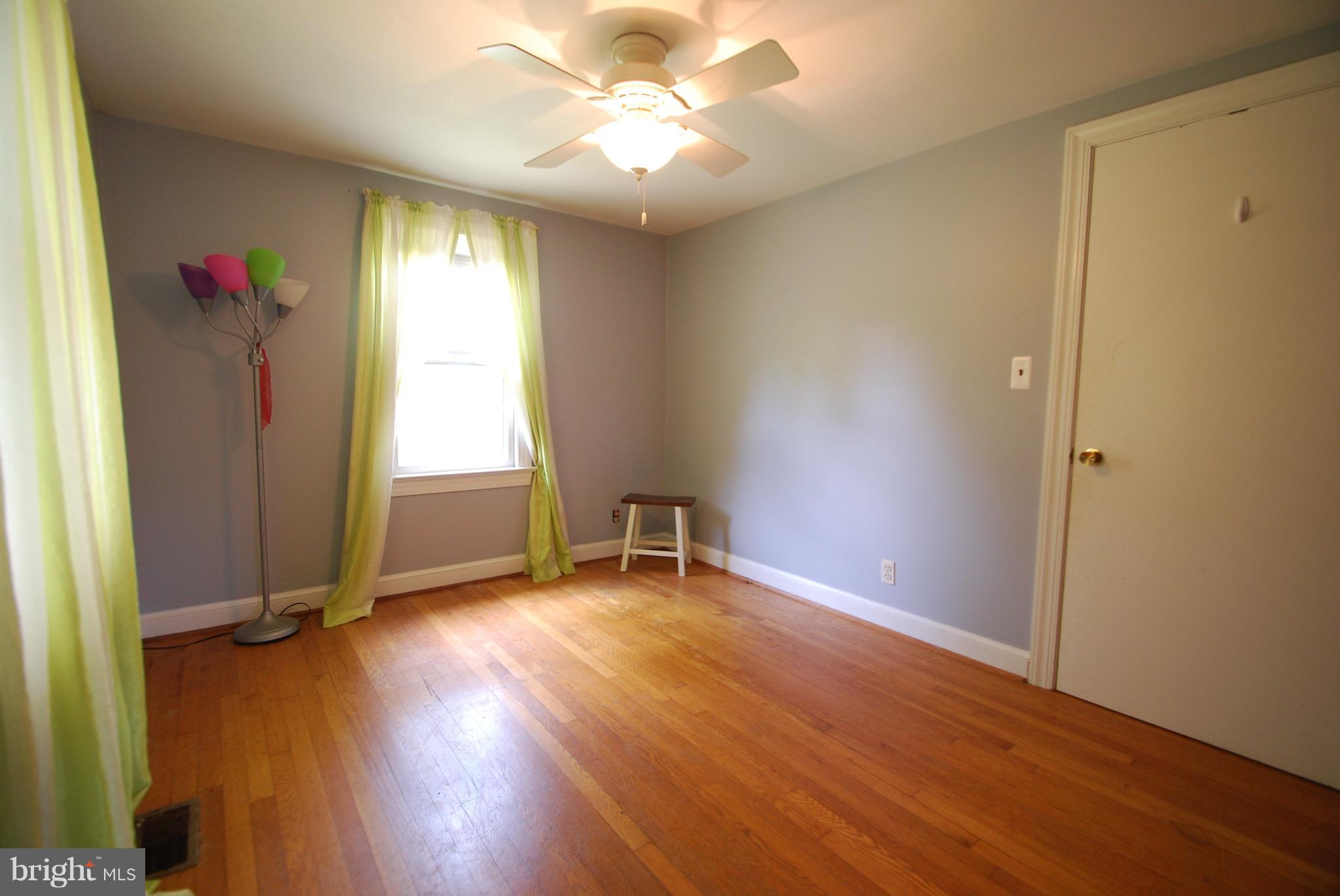 10775 Cliff Mills Road Marshall, VA 20115 - Photo 6 of 17 an empty room with wooden floor and windows