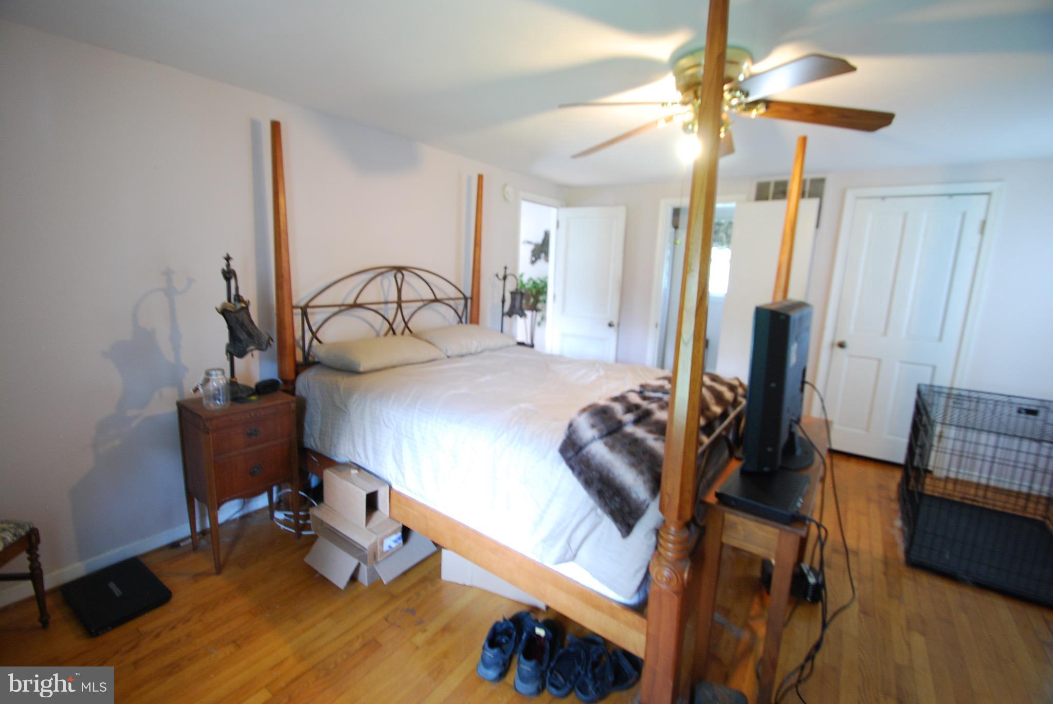 10775 Cliff Mills Road Marshall, VA 20115 - Photo 10 of 17 a bedroom with furniture and a chandelier