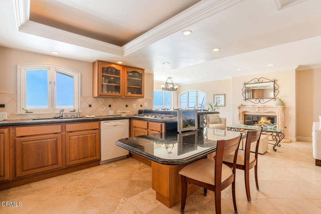 4165 Ocean Drive Oxnard, CA 93035 - Photo 12 of 44 a kitchen with granite countertop wooden cabinets and center island
