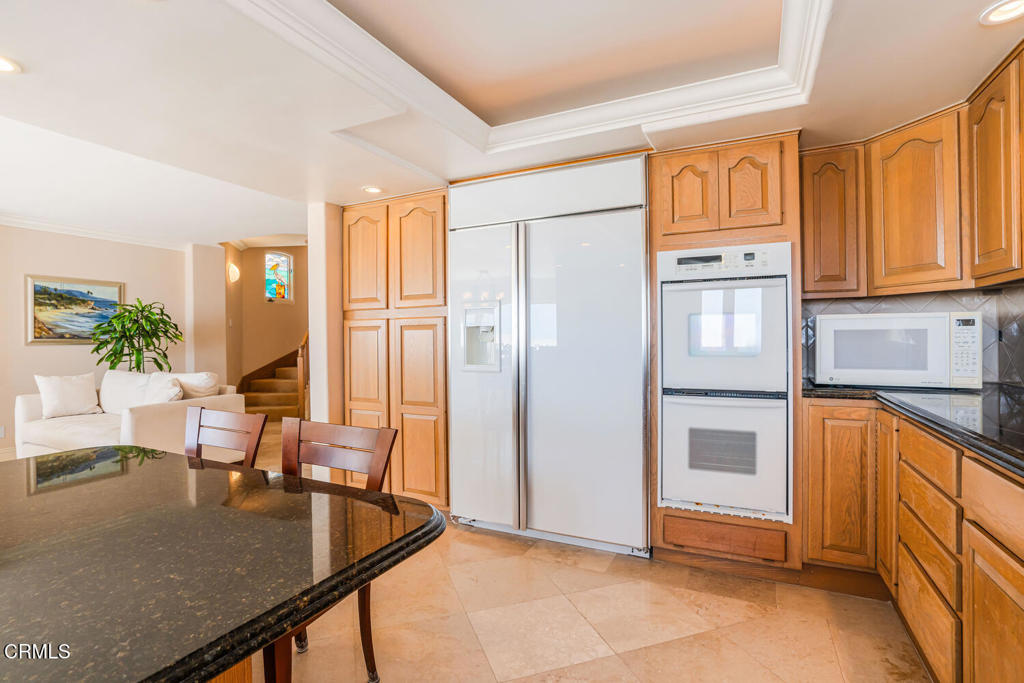 4165 Ocean Drive Oxnard, CA 93035 - Photo 13 of 44 a kitchen with stainless steel appliances granite countertop a refrigerator and a stove top oven