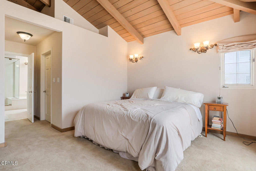 4165 Ocean Drive Oxnard, CA 93035 - Photo 23 of 44 a bedroom with a bed and a chandelier