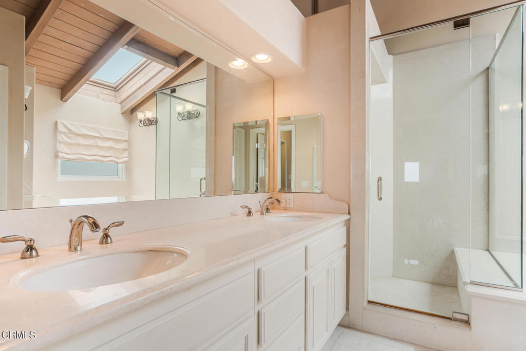 4165 Ocean Drive Oxnard, CA 93035 - Photo 27 of 44 a bathroom with a sink double vanity mirror and a bathtub