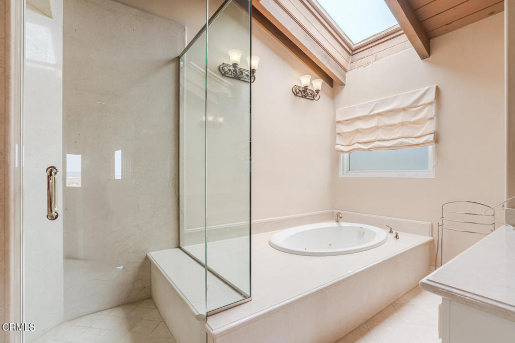 4165 Ocean Drive Oxnard, CA 93035 - Photo 28 of 44 a bathroom with a sink a mirror and a bathtub