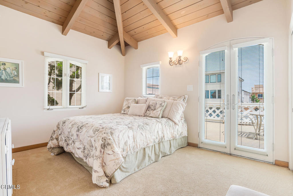 4165 Ocean Drive Oxnard, CA 93035 - Photo 29 of 44 a spacious bedroom with a bed a table and painting on the wall