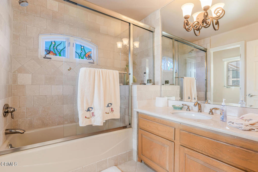 4165 Ocean Drive Oxnard, CA 93035 - Photo 30 of 44 a bathroom with a double vanity sink mirror and bathtub