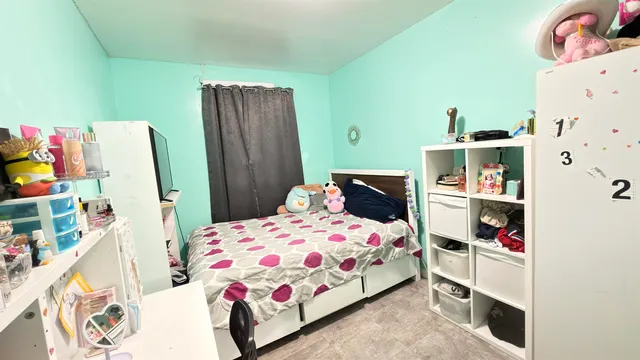 a bedroom with a bed and cabinets