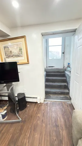 a view of room with wooden floor and windows