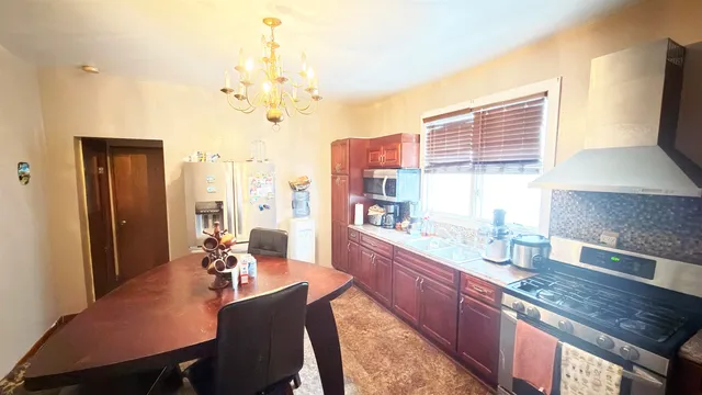 a large kitchen with a table and chairs in it