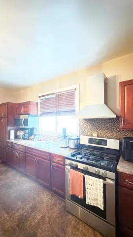 a kitchen with granite countertop a stove and a sink
