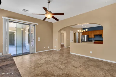 a view of a livingroom with a ceiling fan and window