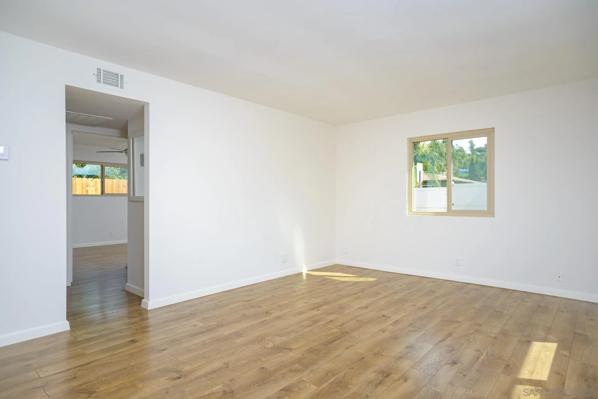 102 Magdalena Drive Oceanside, CA 92057 - Photo 17 of 48 wooden floor in an empty room with a window