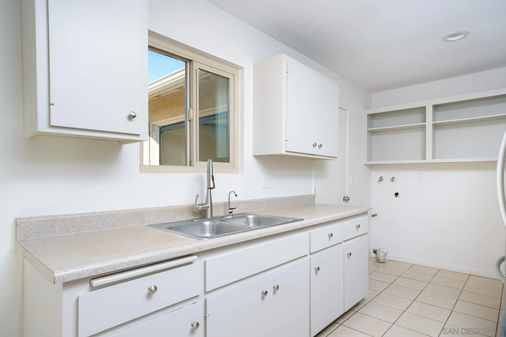 102 Magdalena Drive Oceanside, CA 92057 - Photo 24 of 48 a kitchen with white cabinets and a sink