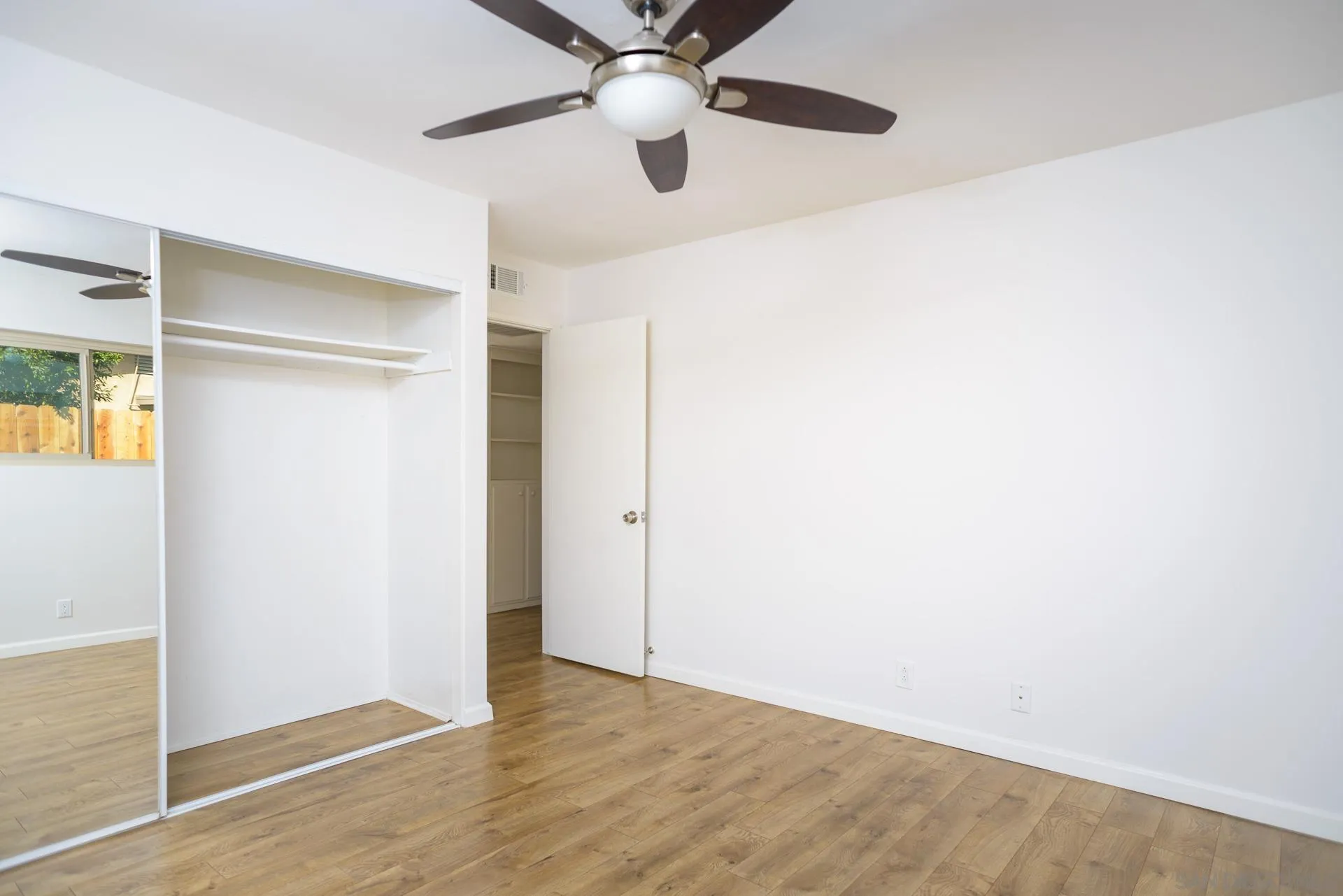 102 Magdalena Drive Oceanside, CA 92057 - Photo 28 of 48 an empty room with a ceiling fan and wooden floor