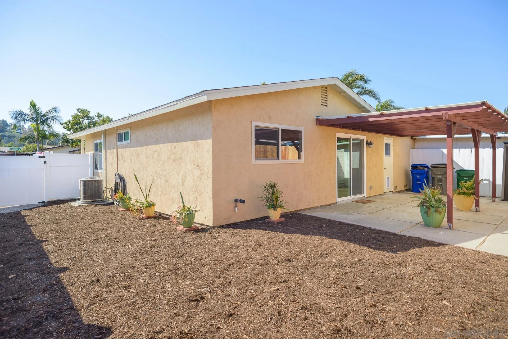 102 Magdalena Drive Oceanside, CA 92057 - Photo 4 of 48 a backyard of a house with barbeque oven table and chairs