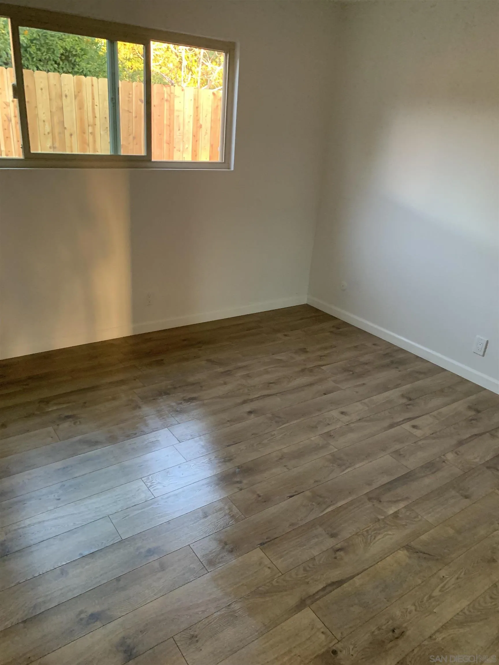 102 Magdalena Drive Oceanside, CA 92057 - Photo 47 of 48 an empty room with wooden floor and windows