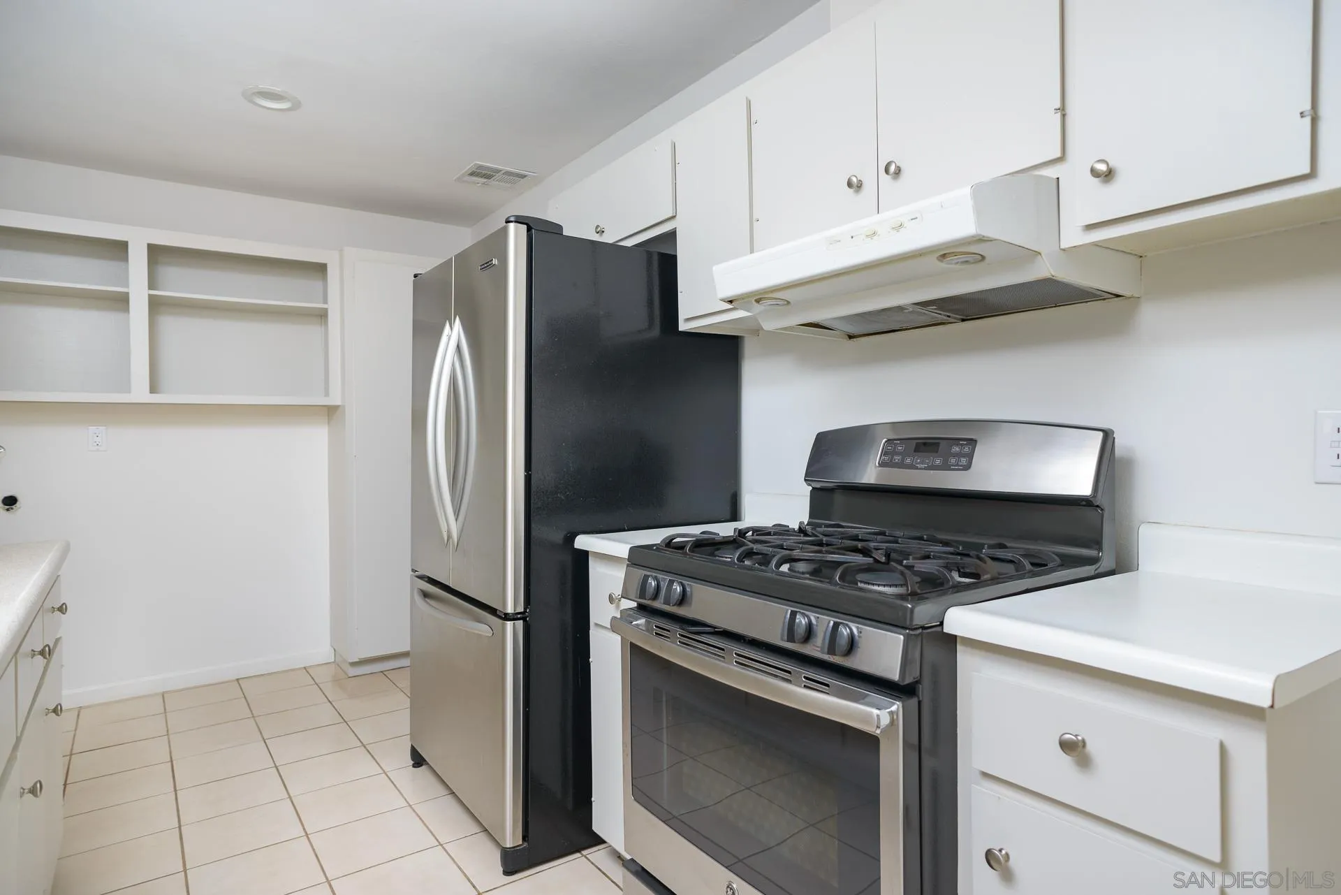 102 Magdalena Drive Oceanside, CA 92057 - Photo 6 of 48 a kitchen with stainless steel appliances a stove and a refrigerator