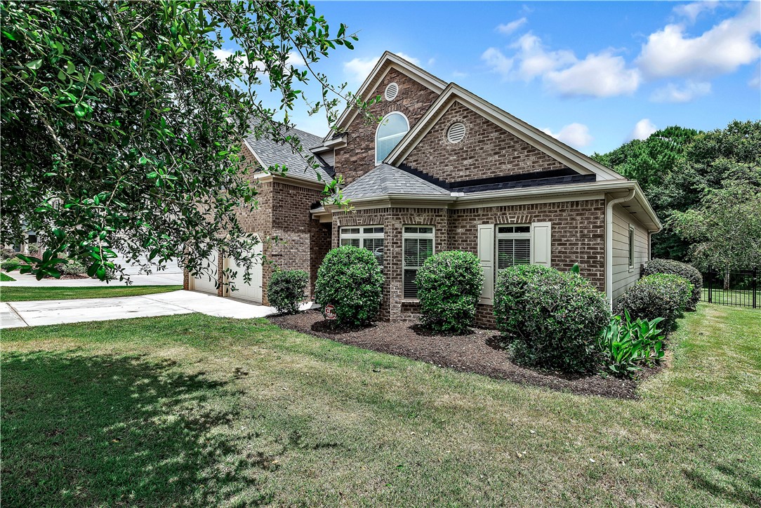 144 Buckland Drive Anderson, SC 29621 - Photo 47 of 48 A classic brick exterior with white shutters and well-maintained landscaping presents charming curb appeal.